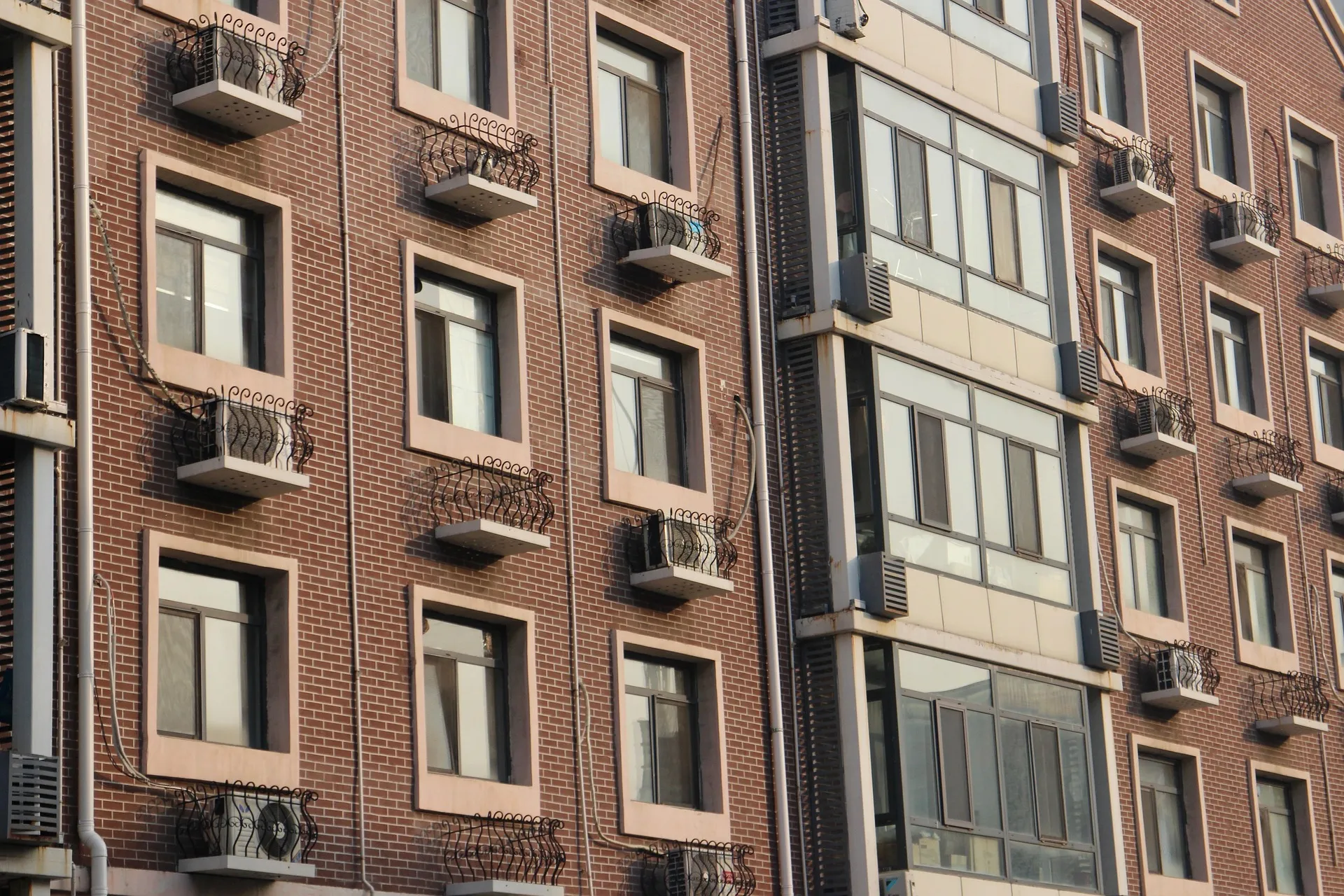 Apartment building with balconies and a clinker brick façade